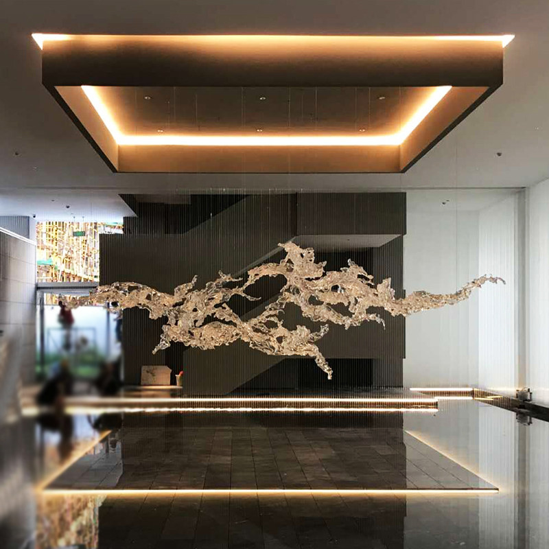 Transparent waves hanging in the air in the hotel lobby, artistic decorative resin ornaments hanging from the ceiling of the sales office in the shopping mall