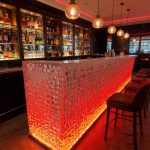 Modern luxury crystal luminous island table, bar, villa, high-end feeling, transparent resin reception, irregular bar counter in front